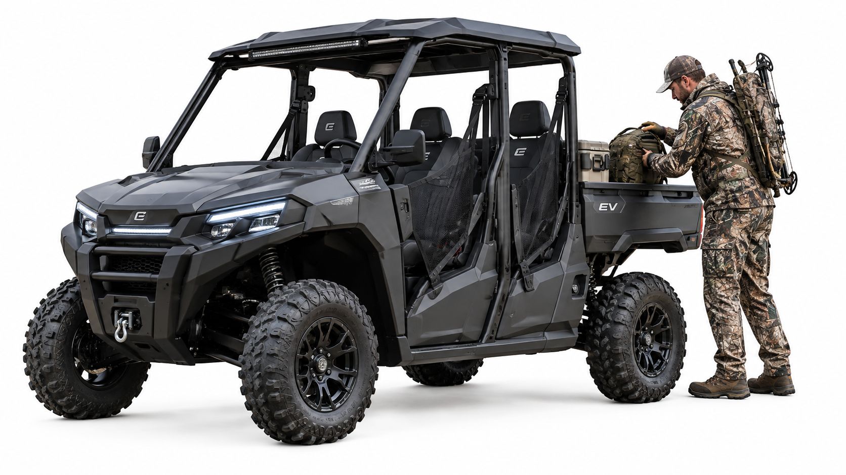 A hunter wearing camouflage gear loads a backpack into the cargo bed of a black electric UTV.